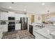 Modern kitchen featuring stainless steel appliances, granite countertops, and a breakfast bar at 1005 Anise Ct, Dacula, GA 30019