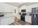 Beautiful white kitchen with granite countertops, stainless steel appliances, and ample cabinet space at 1005 Anise Ct, Dacula, GA 30019