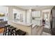 Open-concept kitchen featuring a breakfast bar, granite countertops, and views of the living room at 1005 Anise Ct, Dacula, GA 30019