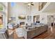 Open living room with a fireplace, soaring ceilings, and large windows for ample natural light at 1005 Anise Ct, Dacula, GA 30019