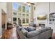 Spacious living room with a soaring ceiling, fireplace, and large windows overlooking the backyard at 1005 Anise Ct, Dacula, GA 30019