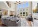 Bright, modern living room with high ceilings and a wall of windows to a well maintained yard at 1005 Anise Ct, Dacula, GA 30019