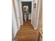 Hallway showcasing hardwood floors leading to bathroom with tiled walls at 1075 Peachtree Ne Walk # 506, Atlanta, GA 30309