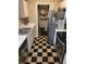 Galley kitchen with stainless steel appliances and checkerboard tile floor at 1075 Peachtree Ne Walk # 506, Atlanta, GA 30309