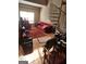 Cozy living room with red sofa, spiral staircase and hardwood floors at 1075 Peachtree Ne Walk # 506, Atlanta, GA 30309