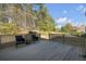 Wooden back deck featuring furniture with wooded scenery at 120 Milano Sw Dr, South Fulton, GA 30331