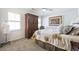 Cozy bedroom with neutral tones, complemented by a quilted bedspread and an antique armoire at 120 Milano Sw Dr, South Fulton, GA 30331