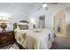 Bedroom with a floral comforter, wood furniture, and attached bathroom at 120 Milano Sw Dr, South Fulton, GA 30331