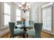 Sunlit breakfast nook with a glass table, chandelier, and bay windows at 120 Milano Sw Dr, South Fulton, GA 30331