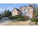 Brick house showcasing detailed architecture, manicured shrubbery, and well-maintained grounds at 120 Milano Sw Dr, South Fulton, GA 30331