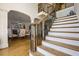 Grand staircase leading to the upper level, with dining area visible through an archway at 120 Milano Sw Dr, South Fulton, GA 30331