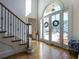 Stately foyer with hardwood floors, staircase, and front doors with large windows and décor at 120 Milano Sw Dr, South Fulton, GA 30331
