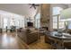 Bright open-concept living room with stone fireplace and hardwood floors at 120 Milano Sw Dr, South Fulton, GA 30331