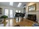 Open-concept living room featuring a grand piano, built-in shelving, and french doors at 120 Milano Sw Dr, South Fulton, GA 30331