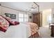 Comfortable bedroom featuring a canopy bed with patterned linens and a glimpse into the attached bathroom at 120 Milano Sw Dr, South Fulton, GA 30331