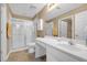 Bathroom featuring a white vanity, toilet, and shower with glass doors at 402 Silver Summit Se Dr, Conyers, GA 30094