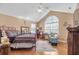 This bedroom features a unique bed frame, ceiling fan, vaulted ceiling, large windows and a workstation at 402 Silver Summit Se Dr, Conyers, GA 30094