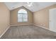 Bright bedroom with neutral carpet, high ceilings, and a large arched window at 402 Silver Summit Se Dr, Conyers, GA 30094