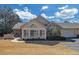 Inviting home exterior featuring a unique arched window and attached garage with paved driveway at 402 Silver Summit Se Dr, Conyers, GA 30094