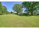 Spacious backyard featuring a large lawn and mature trees at 1214 Marshall Fuller Rd, Dallas, GA 30157