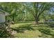Beautiful backyard with green grass, mature trees and a deck, perfect for outdoor enjoyment at 1214 Marshall Fuller Rd, Dallas, GA 30157