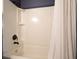 Close-up of the white shower over bath with dark hardware and a white shower curtain at 1214 Marshall Fuller Rd, Dallas, GA 30157
