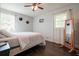 Bedroom with wood floors, bright windows, a bed and a full-length mirror at 1214 Marshall Fuller Rd, Dallas, GA 30157