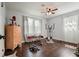 Bright bedroom with wood floors, a dresser, exercise equipment and large windows at 1214 Marshall Fuller Rd, Dallas, GA 30157