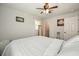 Bright bedroom with wood floors, a ceiling fan, a bed and a full-length mirror at 1214 Marshall Fuller Rd, Dallas, GA 30157