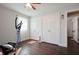 Bedroom with wood floors, a ceiling fan, a large closet, and an elliptical machine at 1214 Marshall Fuller Rd, Dallas, GA 30157