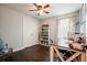 Cozy bedroom with wood floors, a ceiling fan, and a large closet, perfect for an office at 1214 Marshall Fuller Rd, Dallas, GA 30157