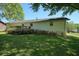 Charming white brick home with a wooden deck and flowering bushes at 1214 Marshall Fuller Rd, Dallas, GA 30157