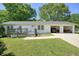 Well-maintained single-story home with a two-car garage and a front deck at 1214 Marshall Fuller Rd, Dallas, GA 30157