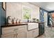 Stylish kitchen with white subway tile, wood counters, a farmhouse sink and stainless steel dishwasher at 1214 Marshall Fuller Rd, Dallas, GA 30157