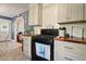 Well-equipped kitchen with stainless steel range and view to living room with chairs at 1214 Marshall Fuller Rd, Dallas, GA 30157