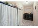 Charming laundry room featuring tile floors and modern black washer and dryer at 1214 Marshall Fuller Rd, Dallas, GA 30157