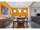 Stylish dining room with a wooden table, orange walls, and modern decor creating a warm, inviting space at 256 Bollen Ln, Hiram, GA 30141