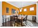 Warm dining room featuring orange walls, dark wood flooring, and a bright, airy atmosphere at 256 Bollen Ln, Hiram, GA 30141