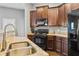 Well-equipped kitchen with granite countertops, stainless steel sink, and black appliances at 256 Bollen Ln, Hiram, GA 30141