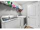 Efficient laundry room offers a washer, dryer, shelving, and storage space for household tasks at 256 Bollen Ln, Hiram, GA 30141