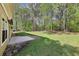 Landscaped backyard featuring a patio and lush greenery at 3479 Portsmouth Cir, Lithonia, GA 30038