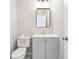 Cozy half bathroom featuring modern vanity, toilet and mirror with stylish lighting at 3479 Portsmouth Cir, Lithonia, GA 30038