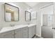 Bathroom featuring double sink vanity, framed mirrors and access to bedroom area at 3479 Portsmouth Cir, Lithonia, GA 30038