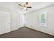 Neutral bedroom with ceiling fan, two windows, and closet for ample storage at 3479 Portsmouth Cir, Lithonia, GA 30038
