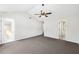 Bedroom featuring vaulted ceiling, fan, private patio door, and bathroom access at 3479 Portsmouth Cir, Lithonia, GA 30038