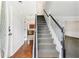 A bright foyer with a staircase and views into the living spaces and kitchen at 3479 Portsmouth Cir, Lithonia, GA 30038