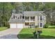 Charming two-story home featuring a welcoming front porch and well-manicured lawn at 3479 Portsmouth Cir, Lithonia, GA 30038