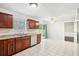 Open-concept kitchen with tile floor, stainless steel dishwasher, wood cabinets, and backyard access at 3479 Portsmouth Cir, Lithonia, GA 30038