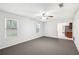 Open-concept living room showcasing two windows and easy access to kitchen area at 3479 Portsmouth Cir, Lithonia, GA 30038