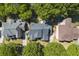 Aerial view showcasing the home's roof, lush landscaping, and convenient driveway with ample parking at 4862 Tarry Post Ln, Suwanee, GA 30024